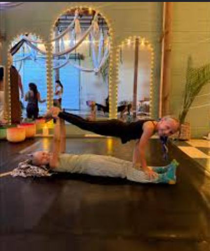 Two kids doing acro yoga together