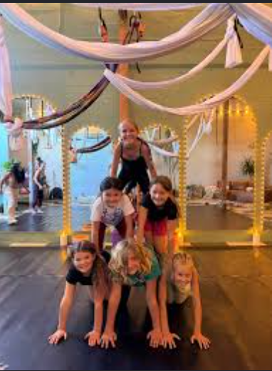 Kids building a human pyramid in the aerial lounge