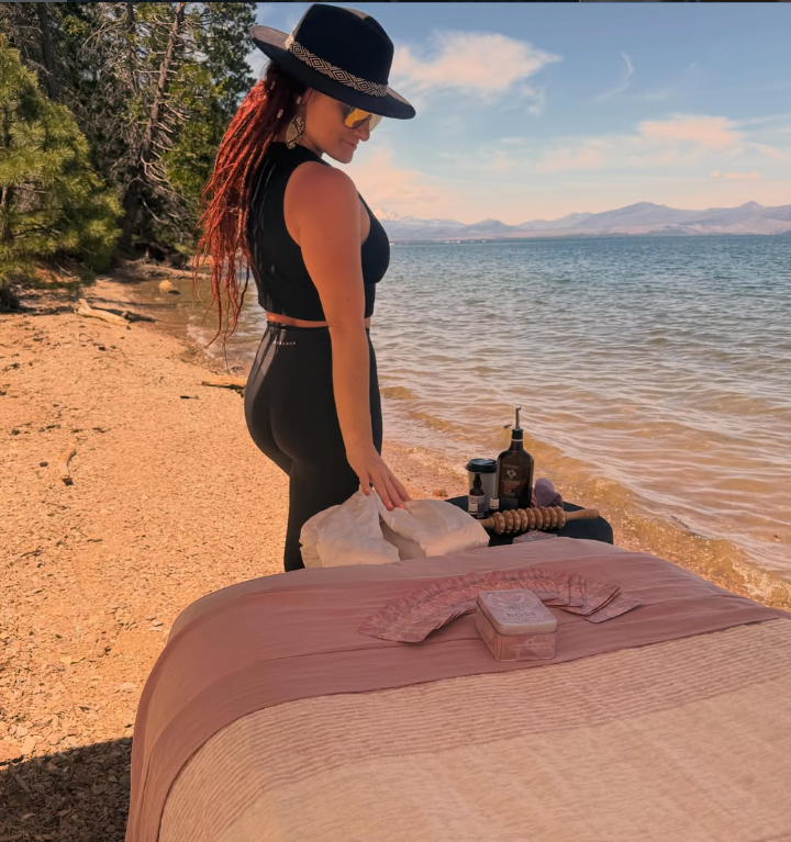 Christina setting up a lakeside massage table in Paradise